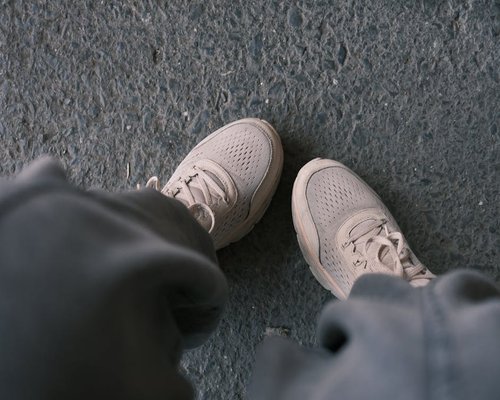 Detail of comfortable walking shoes on a city pavement