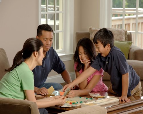 Family playing a board game in the evening