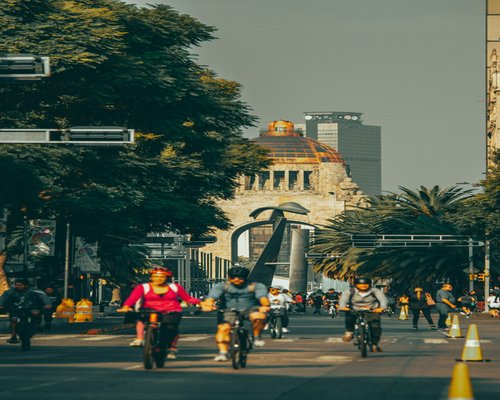 People crossing a busy intersection in a Mexican city